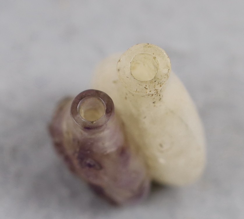 A 19th century Chinese quartz double snuff bottle, 6cm, the carver skilfully incorporating the amethyst crystal inclusions to the relief carving of the front bottle